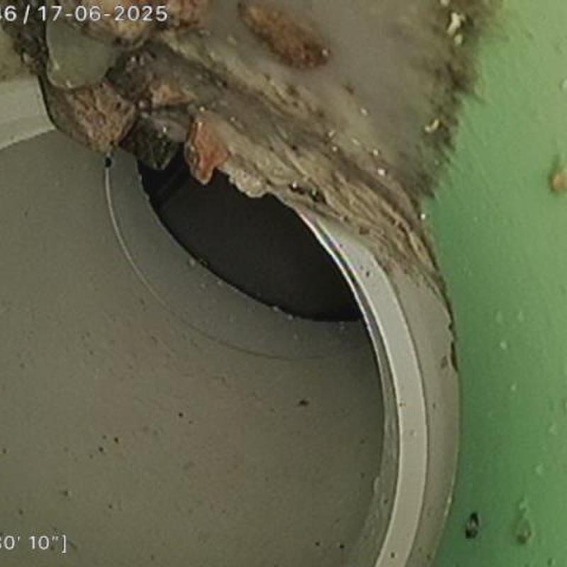 8-inch sewer lateral pipe with visible debris buildup 8-inch sewer lateral pipe with visible debris buildup