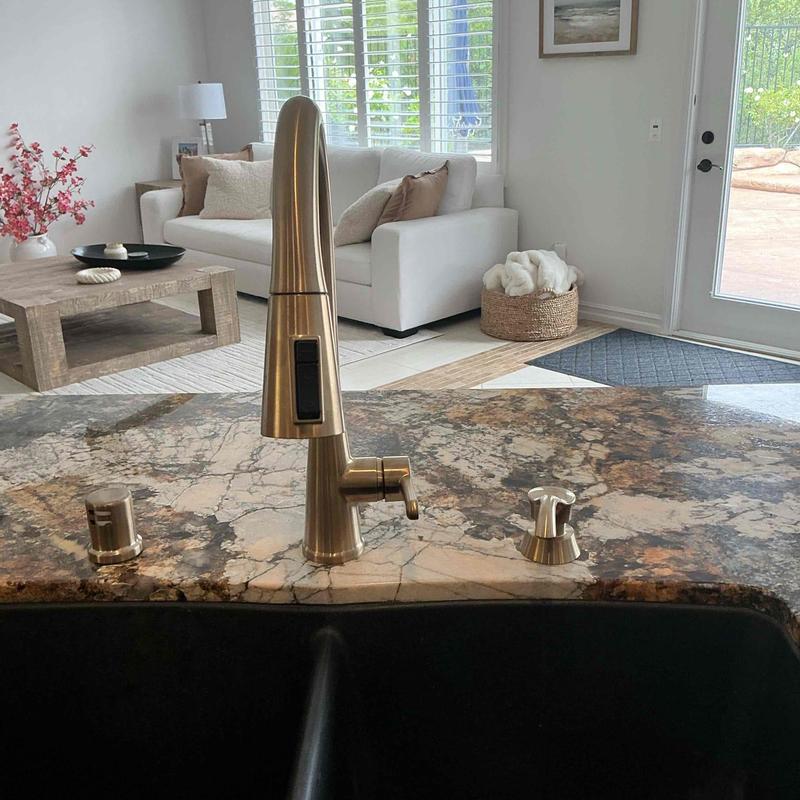 Brushed nickel kitchen faucet installed on granite countertop