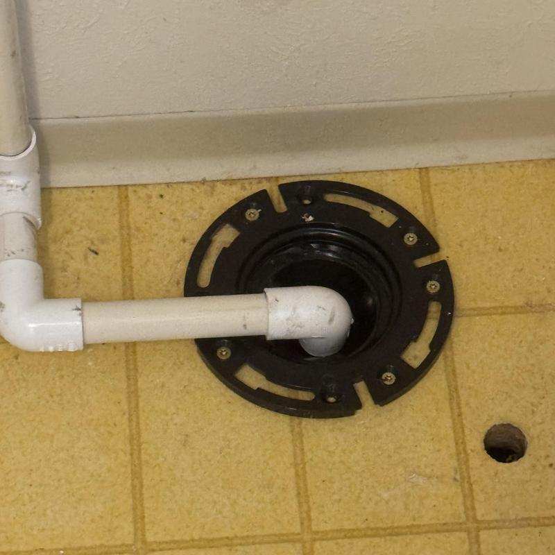 Tankless water heater condensate floor drain installation