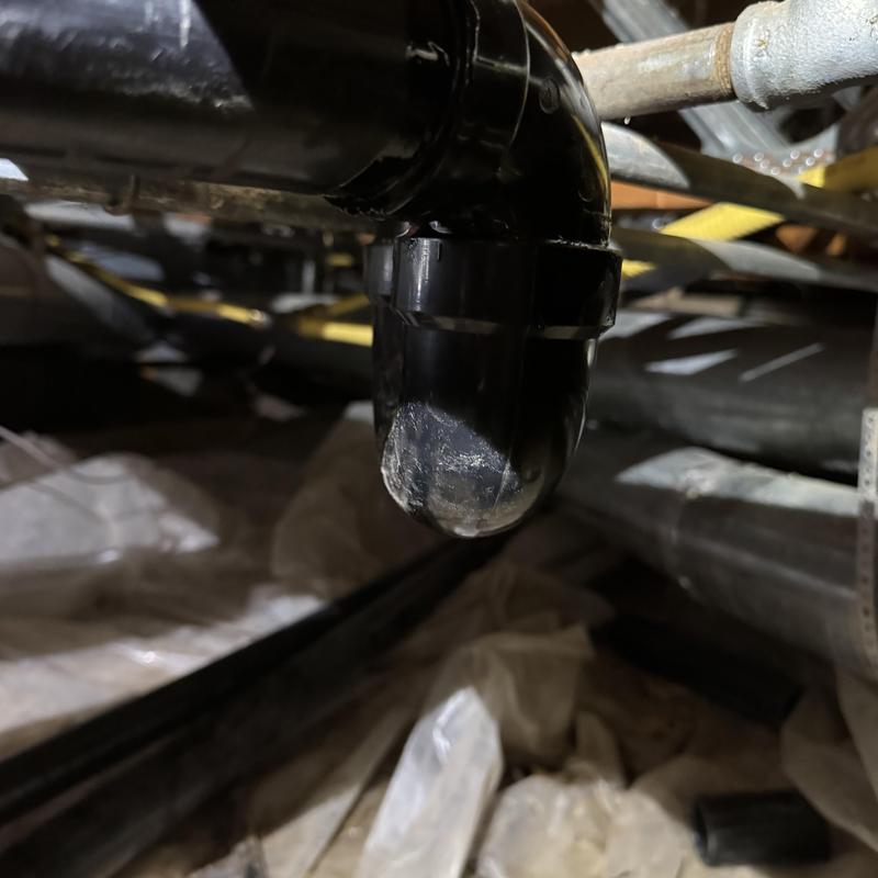 Tankless water heater condensate drain pipe close-up