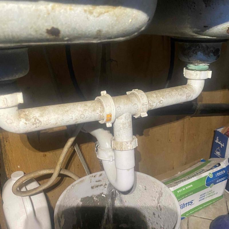 Kitchen sink drain pipe leaking into bucket below