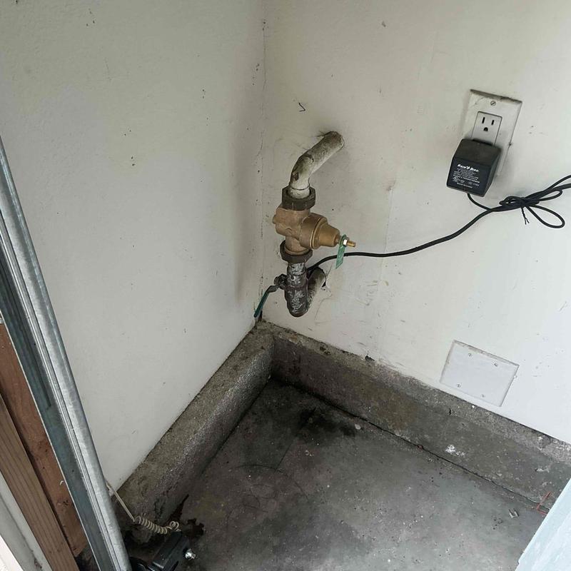 1-inch pressure regulator with connected piping in corner