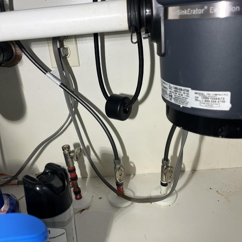 Garbage disposal connections and water supply valves under sink