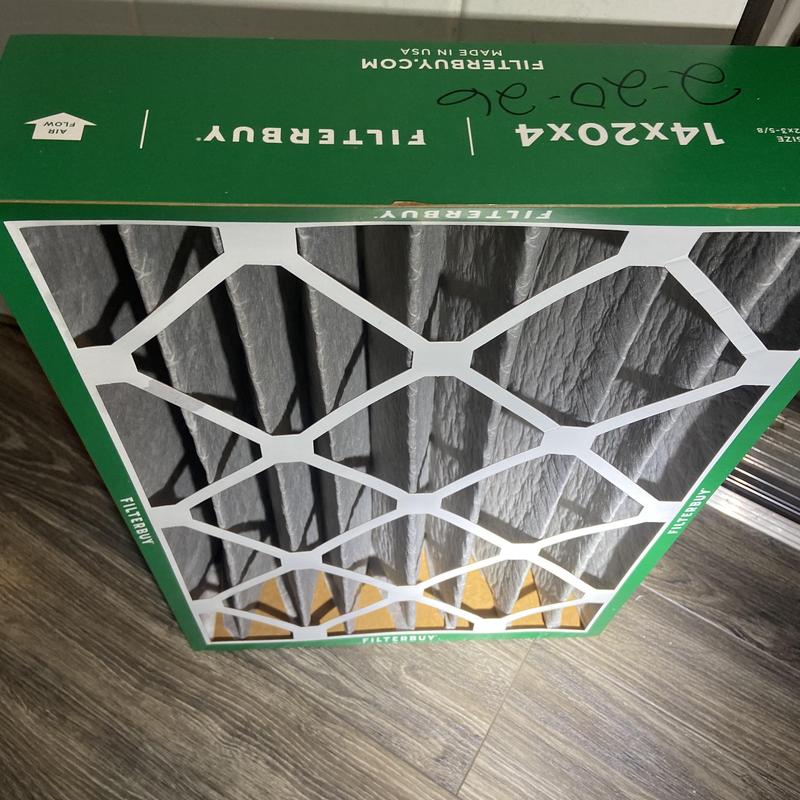 HVAC air filter in packaging on wood floor HVAC air filter in packaging on wood floor