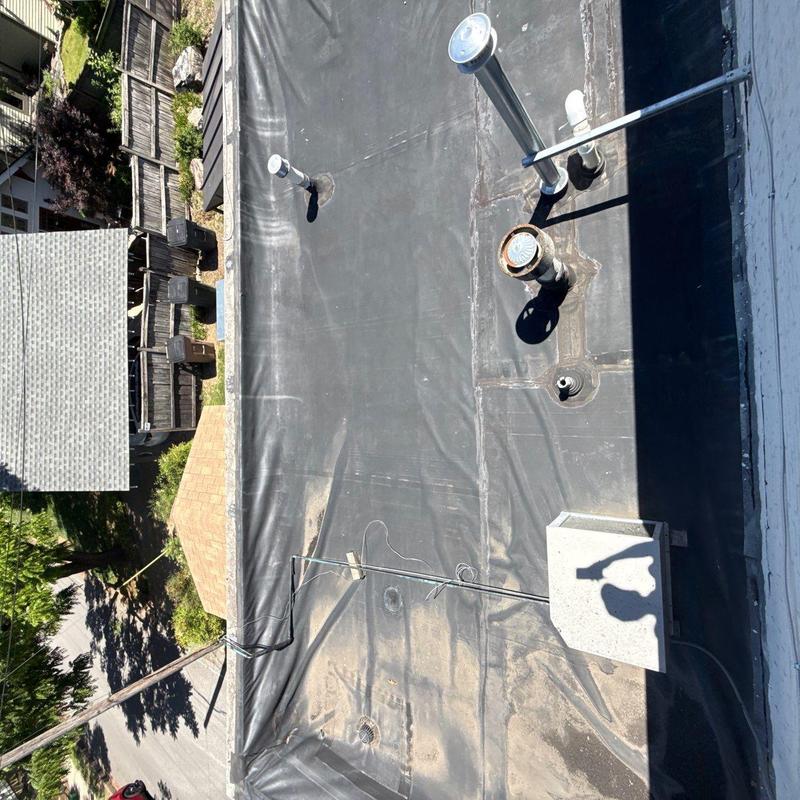 EPDM roofing membrane with aged wrinkling and drains