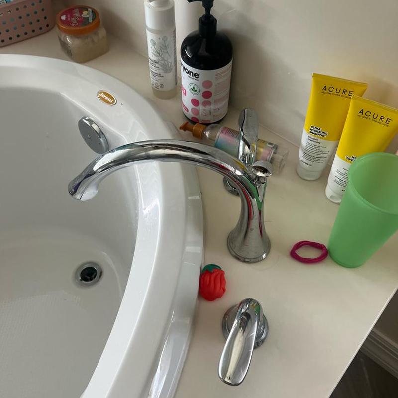 Bathroom sink faucet with surrounding toiletries