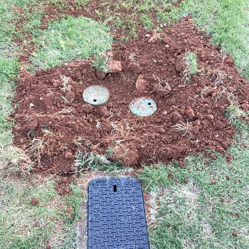 Irrigation system valve box and exposed soil patch