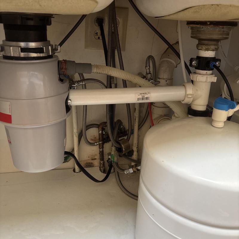 Kitchen sink plumbing and water softener tank installation Kitchen sink plumbing and water softener tank installation