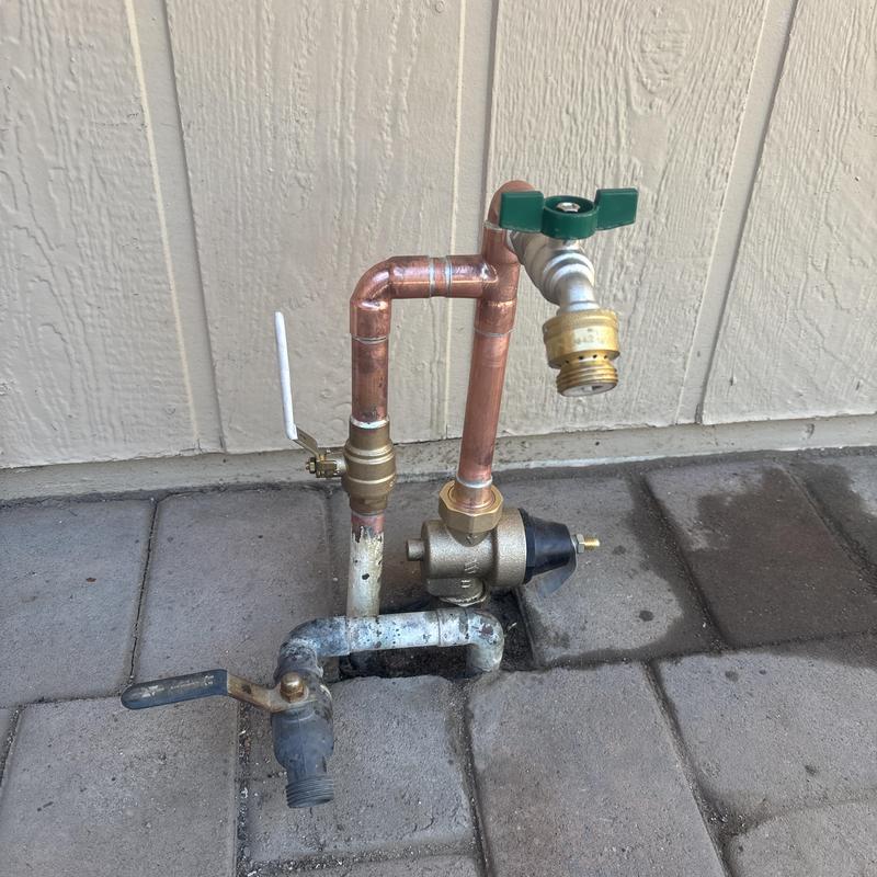 Water main entry with copper pipes and valves Water main entry with copper pipes and valves