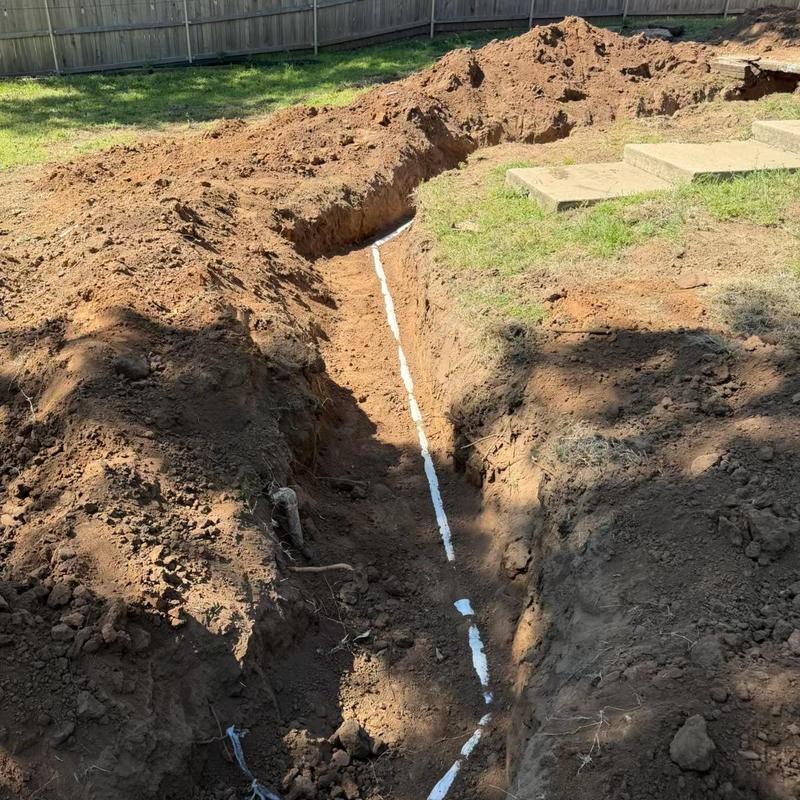 Sewer service line trench with new piping installation Sewer service line trench with new piping installation
