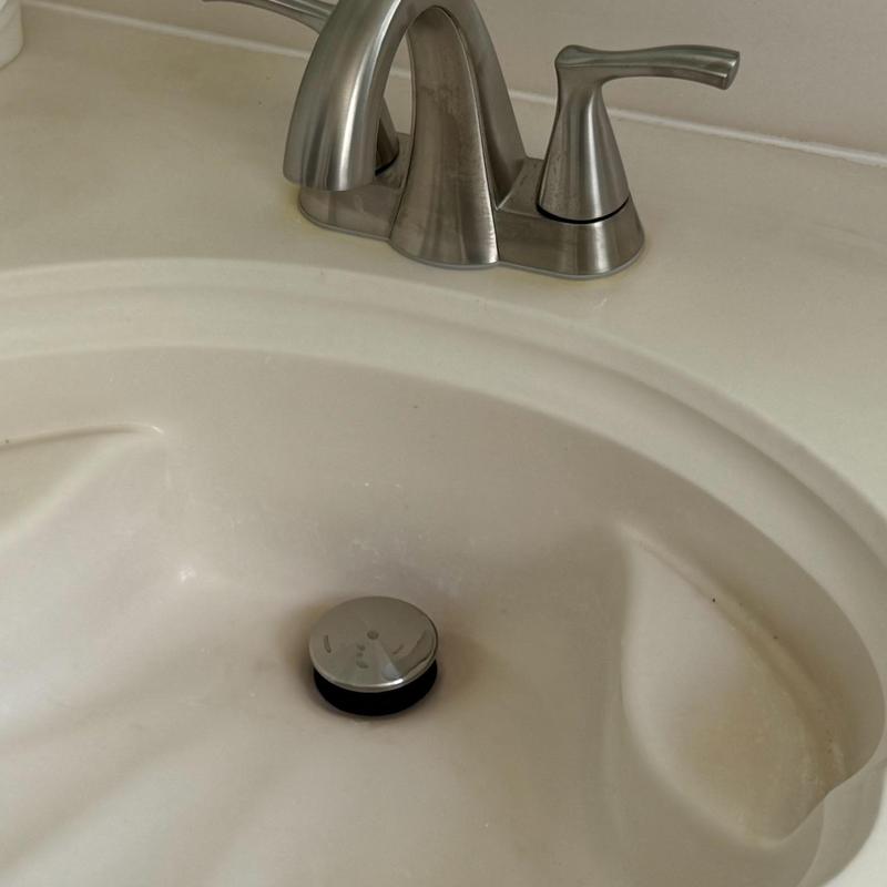 Lavatory faucet and sink with drain stopper installed Lavatory faucet and sink with drain stopper installed