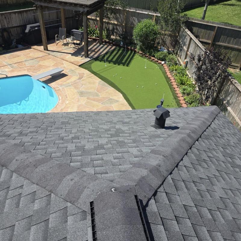 Asphalt shingle roof inspection over backyard pool and putting green