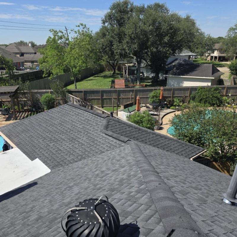 Asphalt shingle roof with ridge vent and vent turbine