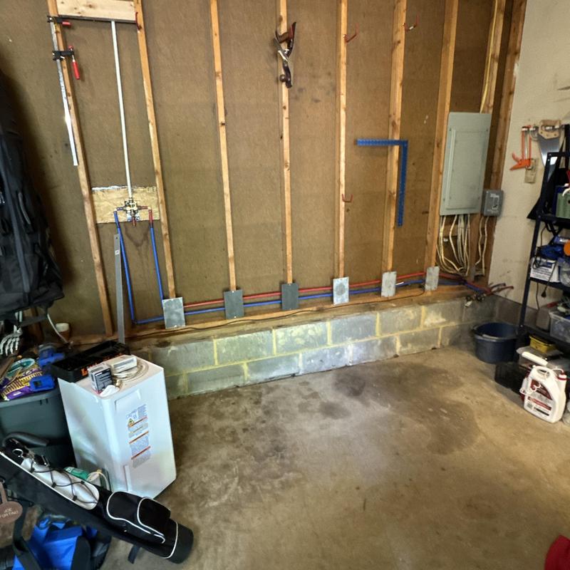Water pipes installed inside wall studs in garage