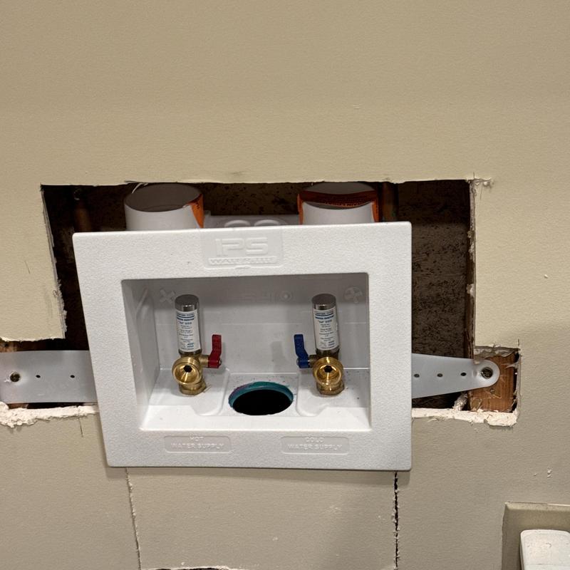 Washing machine box with hot and cold valves installed Washing machine box with hot and cold valves installed