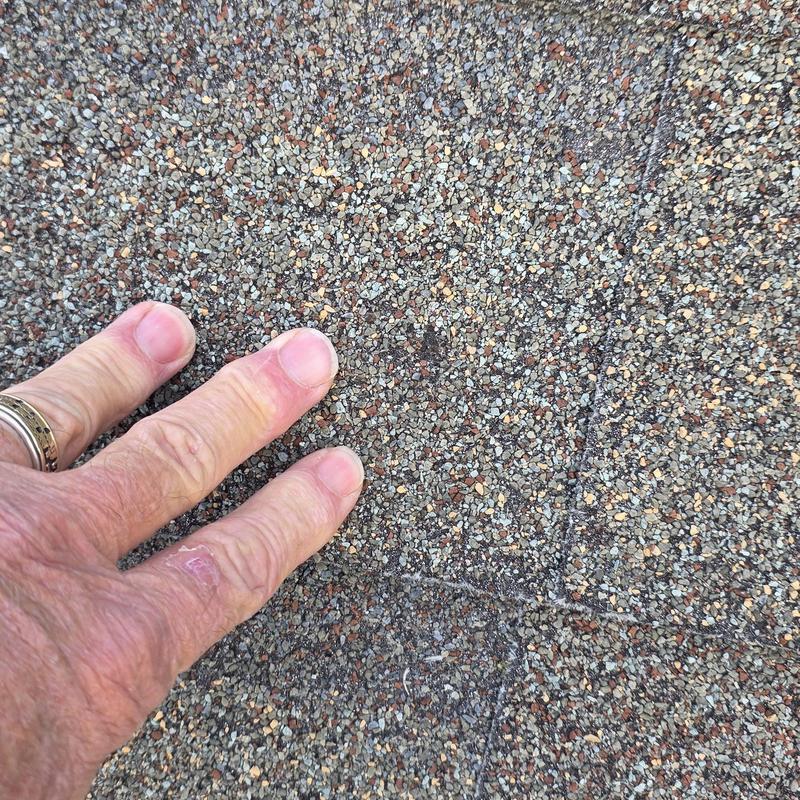 Asphalt roof shingles showing hail damage close-up