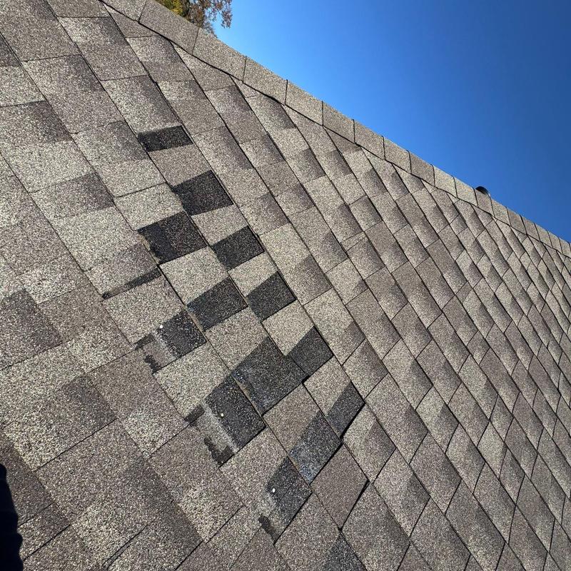 Asphalt shingle roof with hail damage and wear