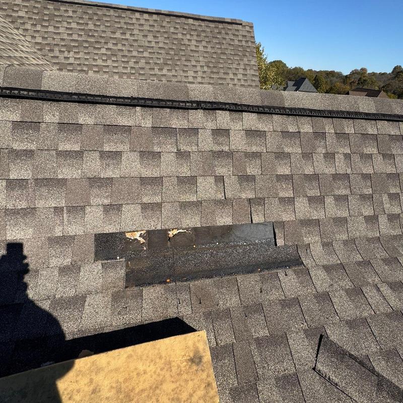 Asphalt shingles and ridge cap with hail damage
