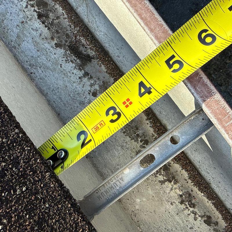 Roof flashing measuring with tape in hail damage inspection
