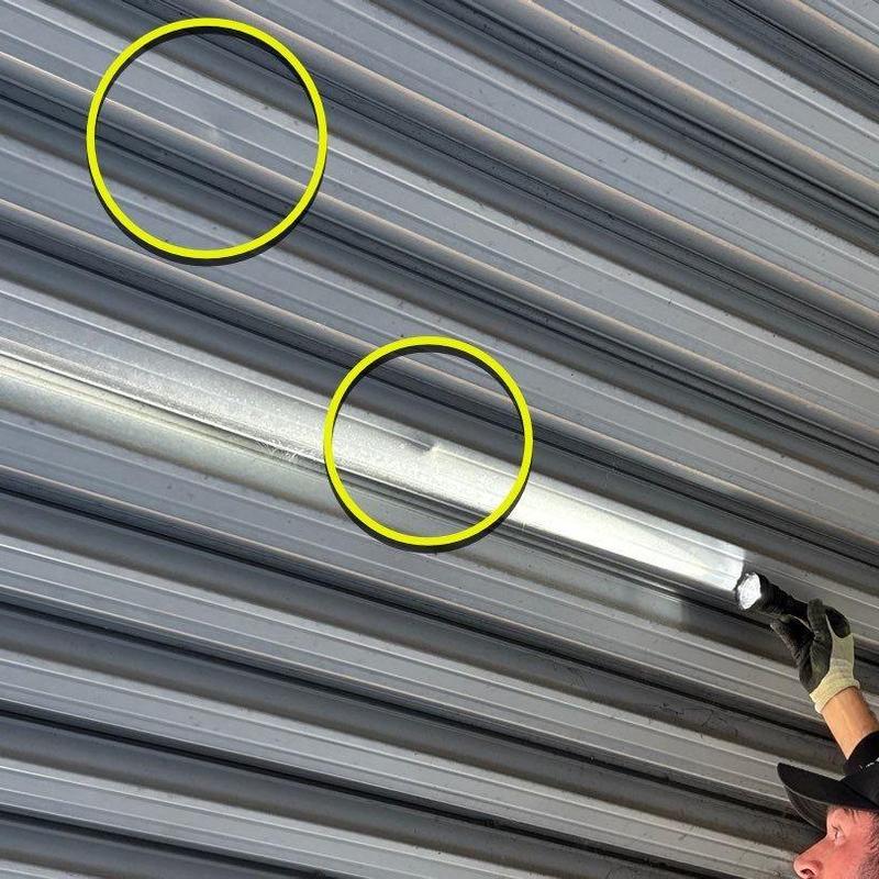 Metal roofing panels with hail damage circled in yellow