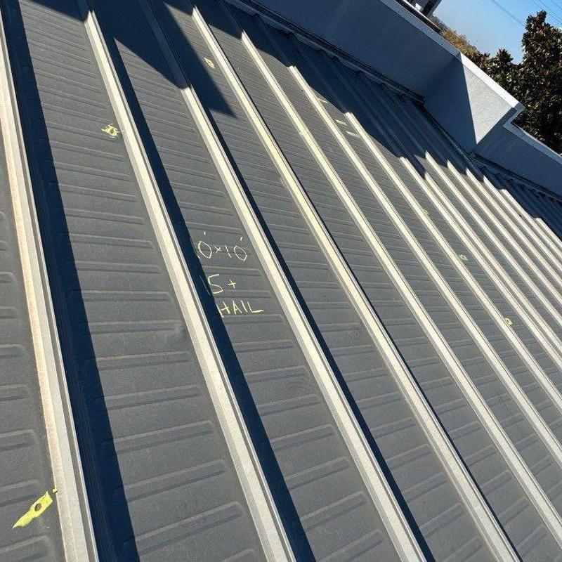 Metal roofing panels with hail damage markings