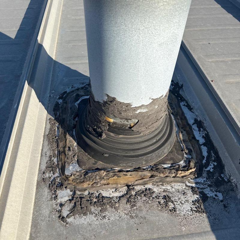 Roof vent flashing with hail damage and deterioration