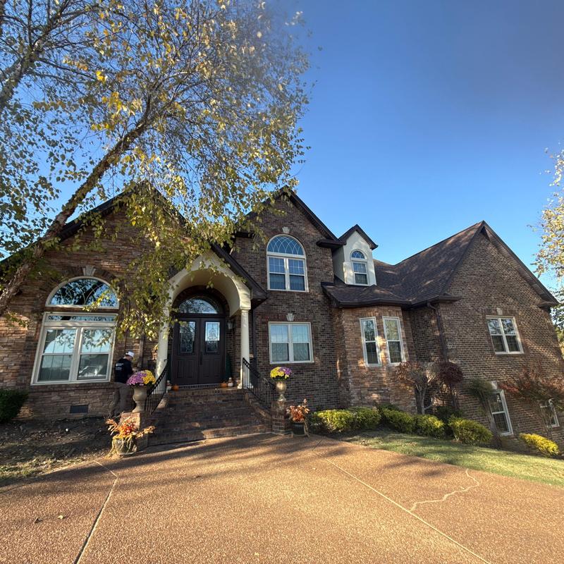 Roof shingles and flashing inspection at brick house