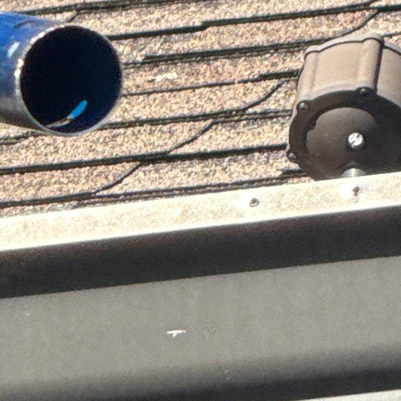 Asphalt shingle roof with vent pipe and ridge vent motor