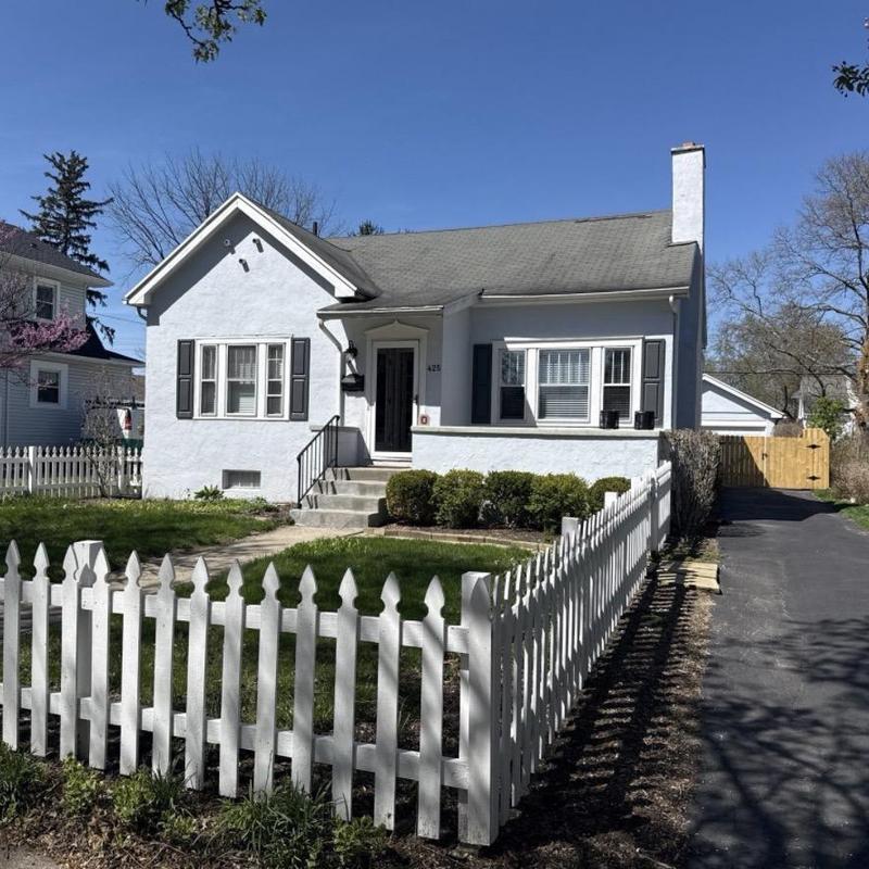 Asphalt shingle roof on white residential home Asphalt shingle roof on white residential home