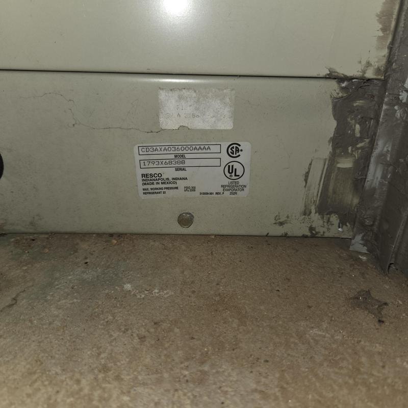 Furnace unit label and surrounding floor area close-up