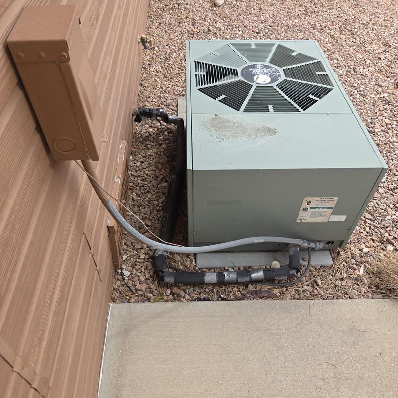 Outdoor HVAC condenser unit with electrical wiring connection