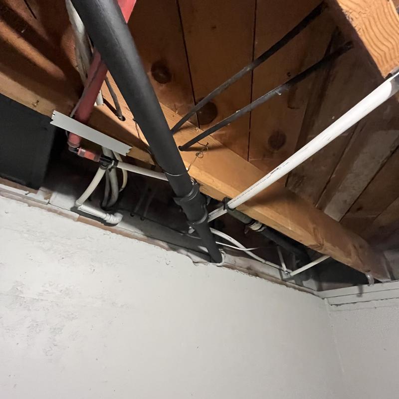 Cast iron to PVC plumbing stack replacement in basement ceiling