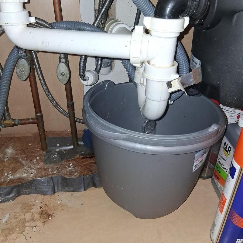 Kitchen drain pipe with bucket catch under sink