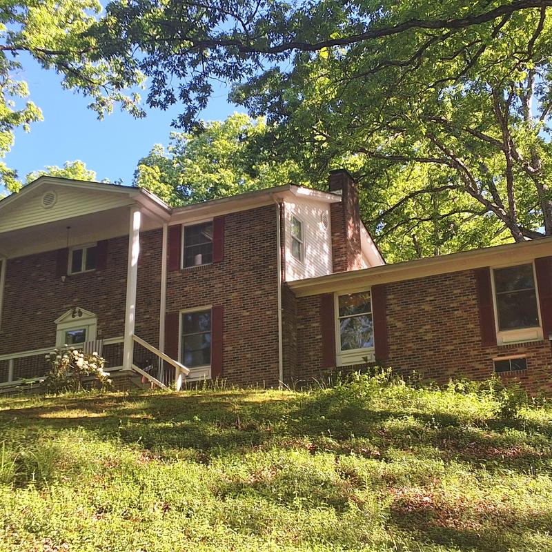Three-tab shingle roof with chimney and brick facade Three-tab shingle roof with chimney and brick facade