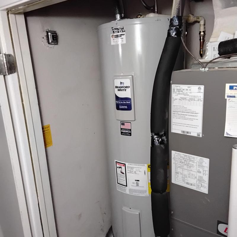 Bradford White electric water heater installed in hallway
