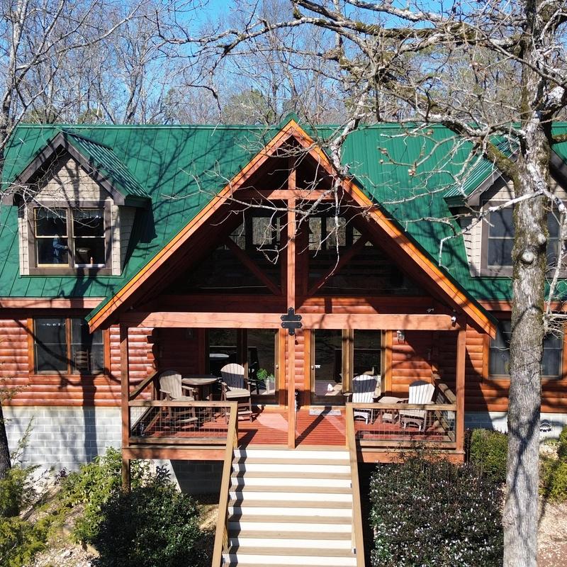 Green metal roofing system on log cabin home