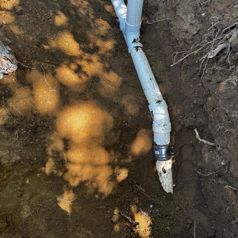 PVC pipe repair with two-way cleanout in trench
