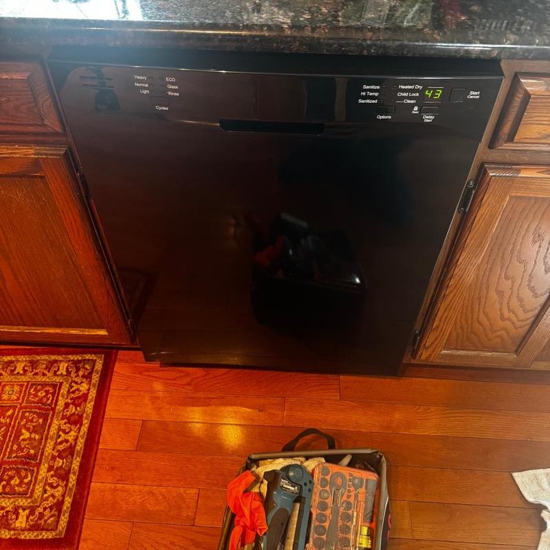 Dishwasher manifold installation with tool kit nearby