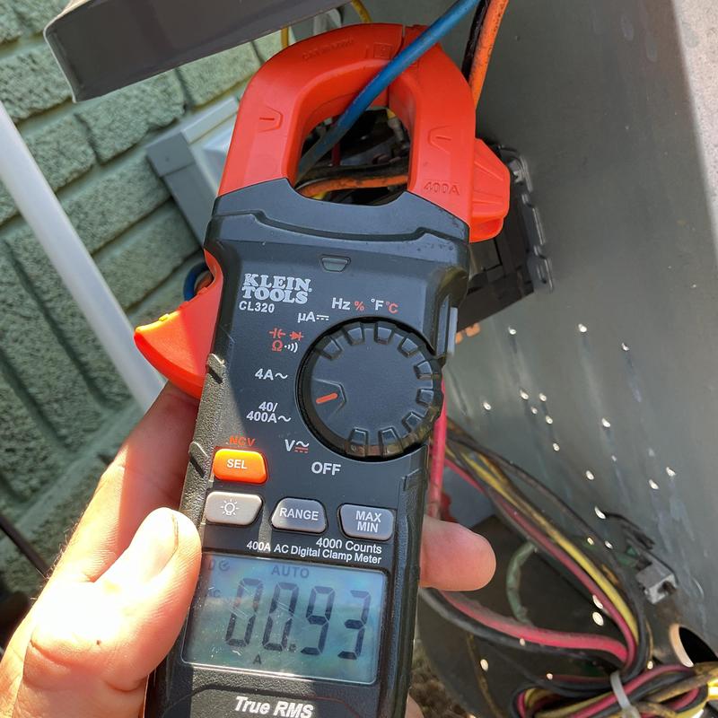 Digital clamp meter measuring HVAC system current Digital clamp meter measuring HVAC system current
