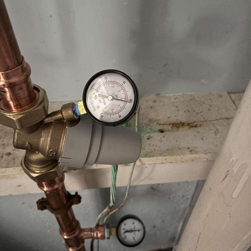 Pressure reducing valve with gauge on copper pipe Pressure reducing valve with gauge on copper pipe