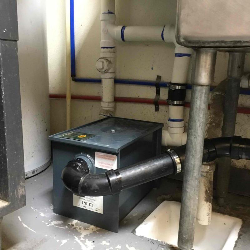 Under sink grease trap and plumbing connections