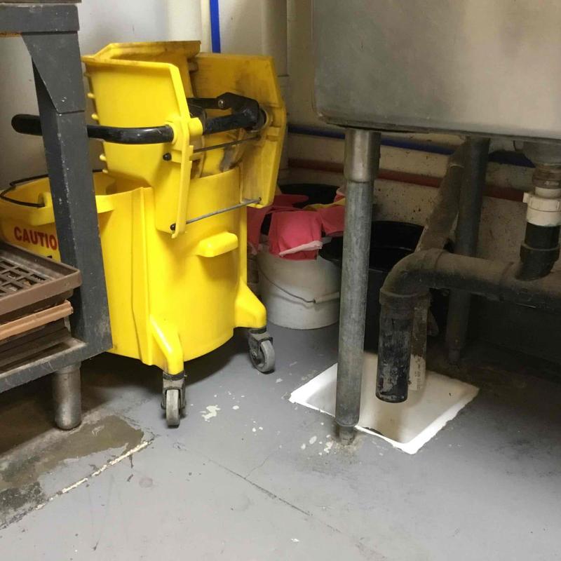 Grease trap plumbing under bakery sink with drain
