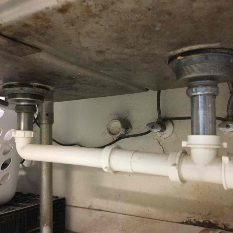 Under sink plumbing with connected grease traps