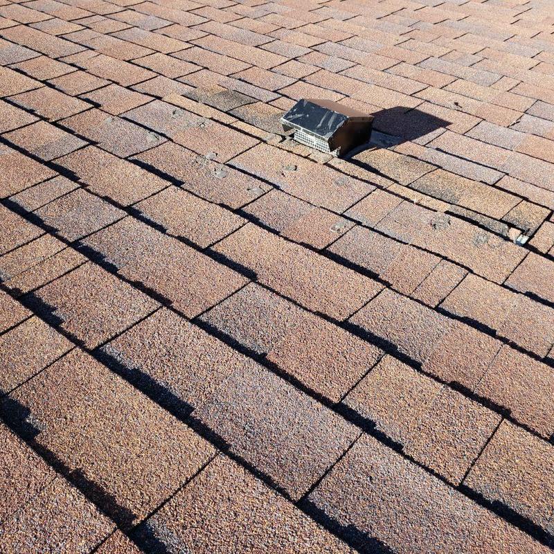 Bathroom roof vent on aging asphalt shingles Bathroom roof vent on aging asphalt shingles