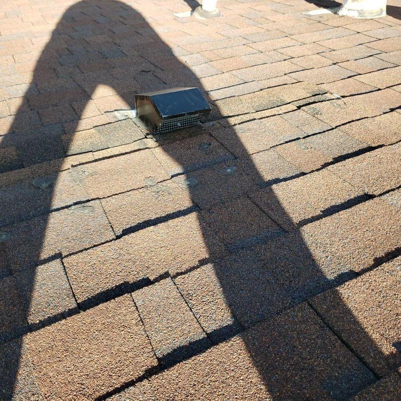 Bathroom roof vent with aged, damaged shingles Bathroom roof vent with aged, damaged shingles