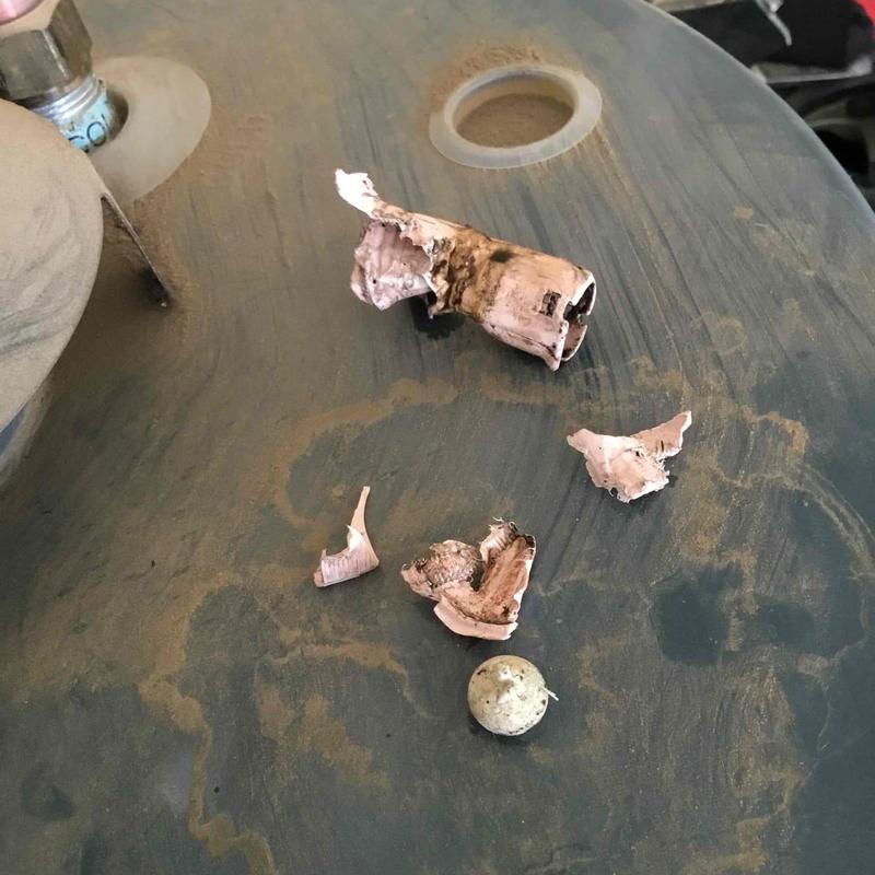 Water heater ball check valve melted debris on tank surface