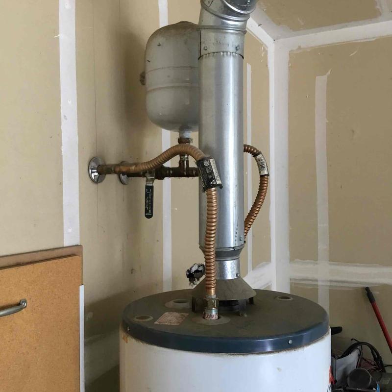Hot water heater with vent pipe and supply lines