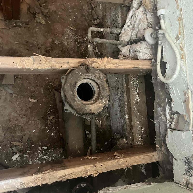 Toilet flange with exposed plumbing under floorboards Toilet flange with exposed plumbing under floorboards