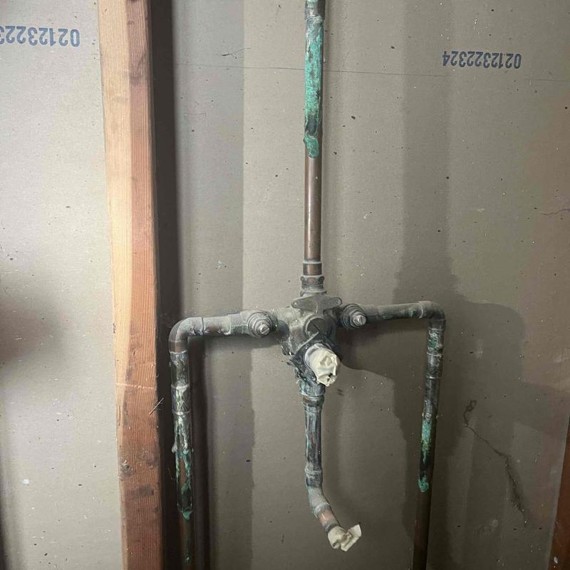 Shower valve and copper piping with corrosion buildup Shower valve and copper piping with corrosion buildup