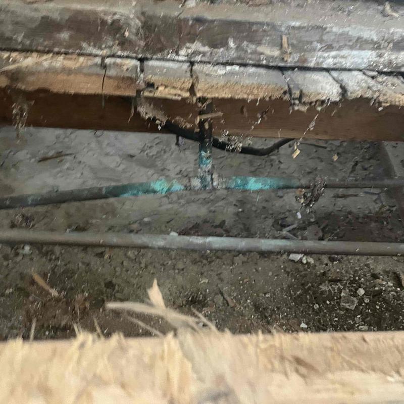 Copper plumbing pipe with visible corrosion and damage Copper plumbing pipe with visible corrosion and damage